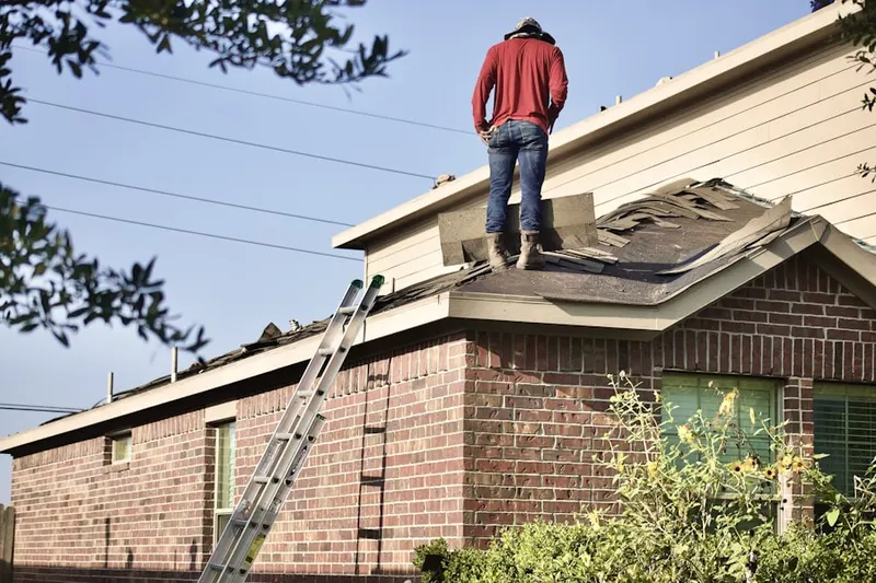 Professional roofer working on a residential roof in Dakota Dunes